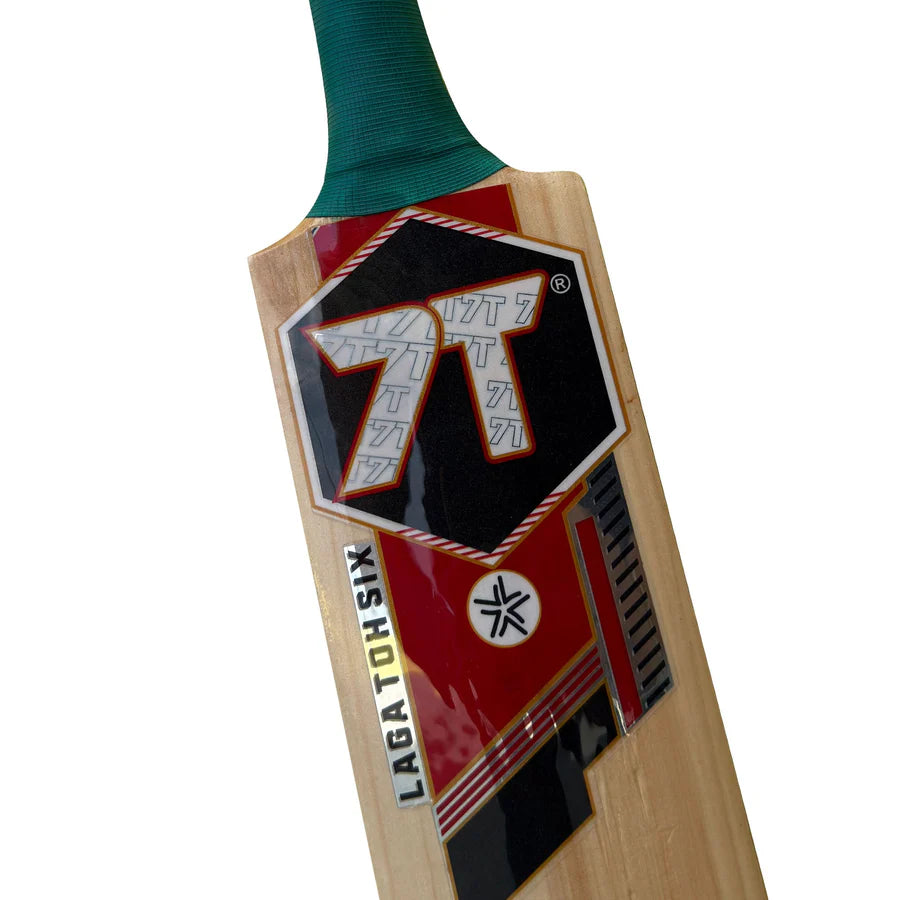 Profile view of the bat toe on the 7T7T Gold Edition Hard Tennis Bat showing the thick edge tapering down to the toe guard.