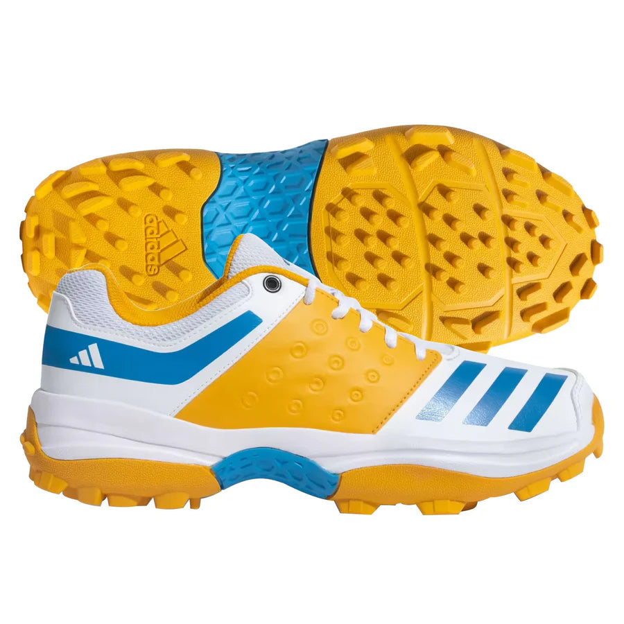 Side view of white and blue Adidas CRINU 23 Cricket Shoes showcasing the synthetic leather upper and iconic stripes.