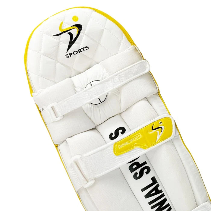 Close-up of DS logo branding patch on the top shoulder of the yellow cricket batting pads