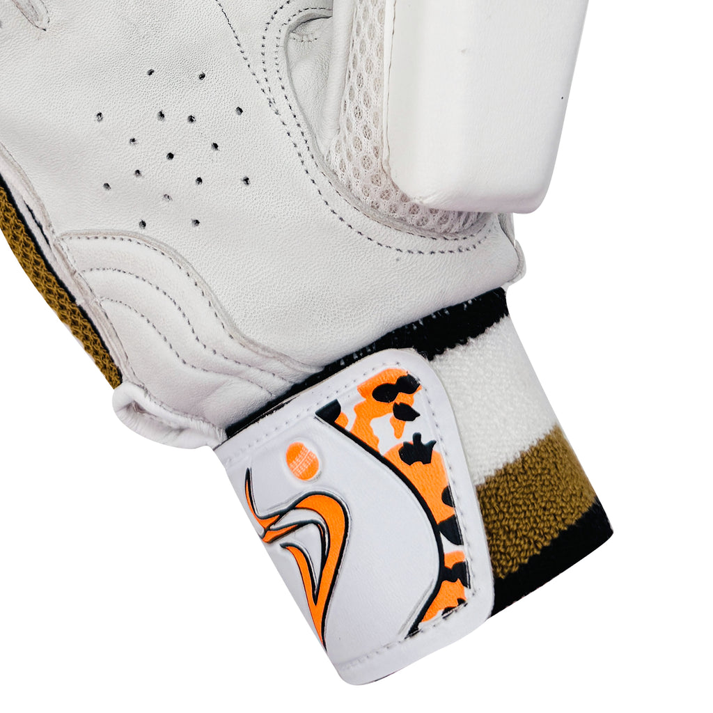 Close-up of the patterned wristband and strap closure on the DS D 1.0 WhiteGold youth cricket batting glove.