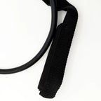 Close-up of black nylon webbing strap with cushioned foam handle for workout stretching band