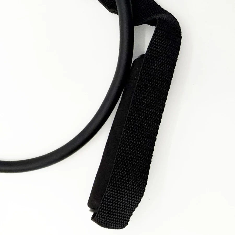 Close-up of black nylon webbing strap with cushioned foam handle for workout stretching band