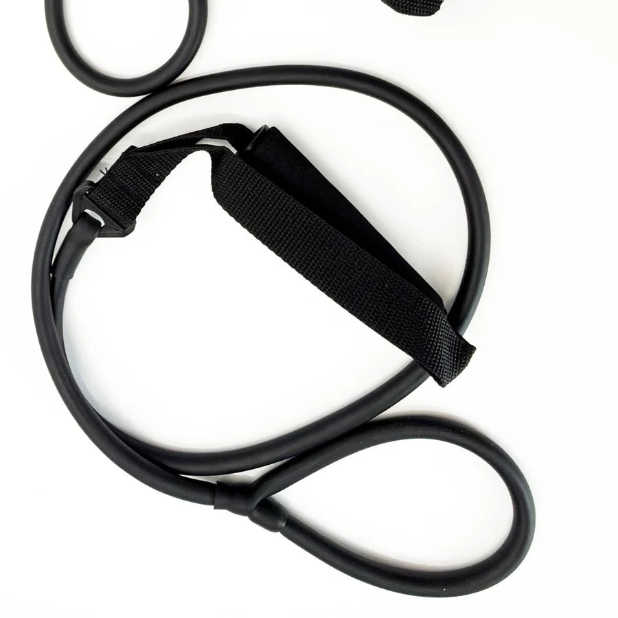 Coiled black exercise stretching band with foam-padded handle strap on white background