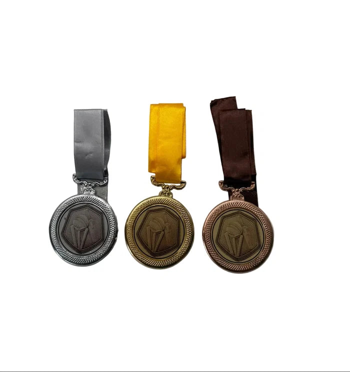 Close-up of 6mm thick 3 Wicket Cricket Medals displaying embossed wickets and ball emblem design
