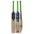 SS Dynasty English Willow cricket bat on a green field, showing its wide profile and premium finish.

