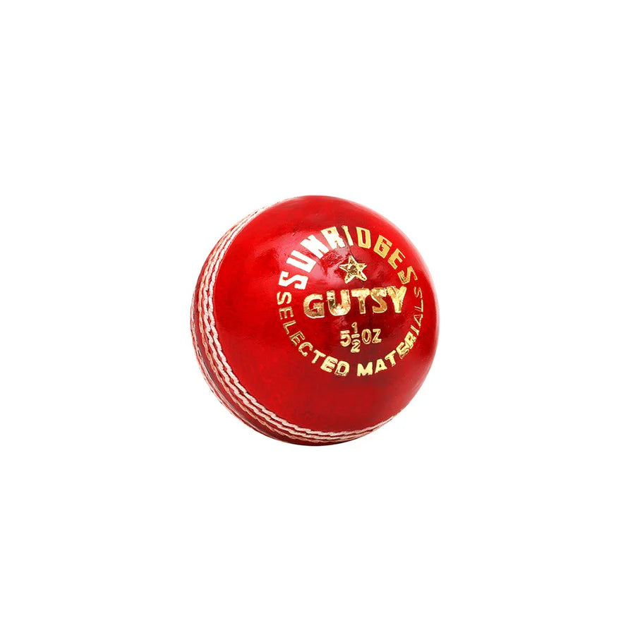 Red SS Gutsy Alum Tanned Cricket Ball showing gold SUNRIDGES stamp and white stitched seam