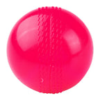 Senior and junior size pink wind cricket balls placed next to a standard cricket bat for scale.